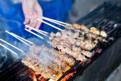 Man preparing food on barbecue grill