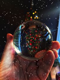 Close-up of hand holding ball with bubbles