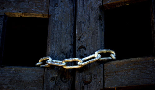 Close-up of closed gate with metallic chain