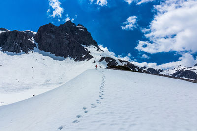 Low angle view of snow covered mountain against sky