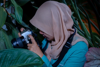 Rear view of woman with camera