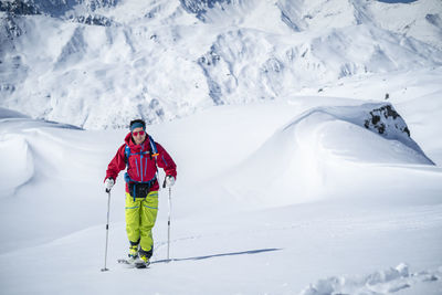 Man skiing on snow covered mountain