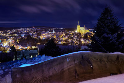 Illuminated cityscape against sky at night