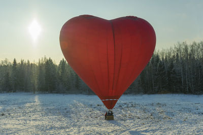 View of hot air balloons on snow covered field