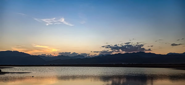 Scenic view of lake against sky during sunset