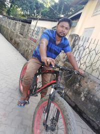 Portrait of young man riding bicycle