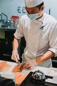 Midsection of man working at table