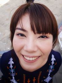 Close-up portrait of smiling young woman