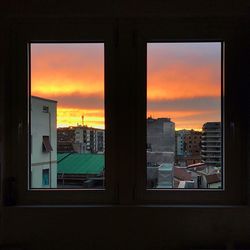 Close-up of cityscape against sky during sunset