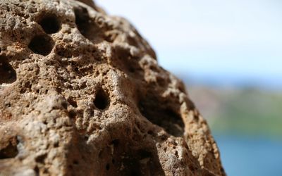 Close-up of rock sculpture against sky