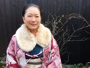 Portrait of smiling woman standing at kiyomizu-dera