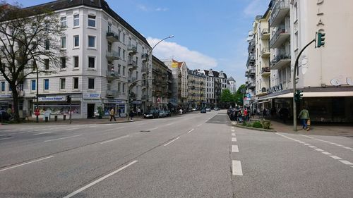 Vehicles on road along buildings