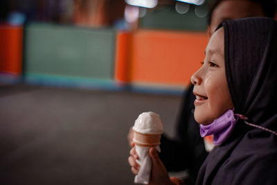 Close-up of young woman holding ice cream cone