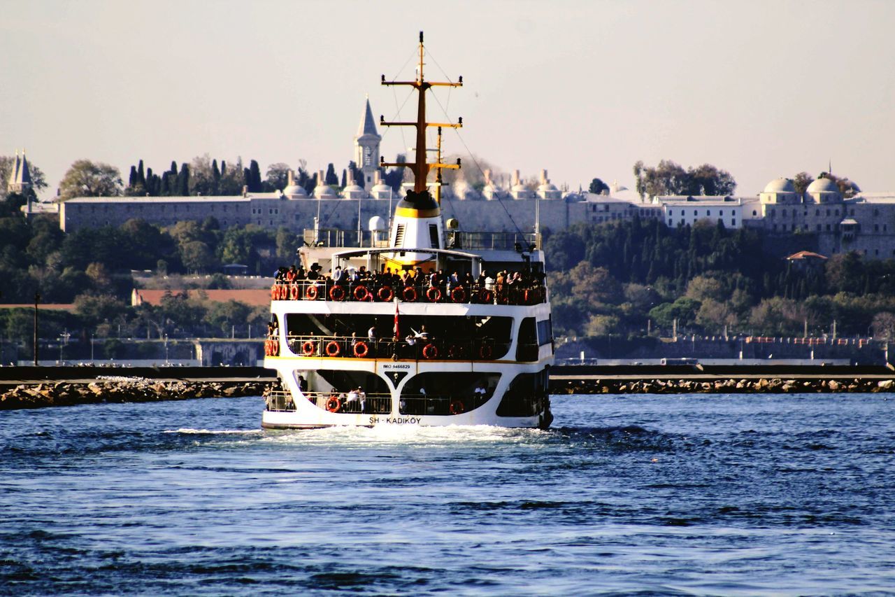 water, nautical vessel, sky, transportation, waterfront, nature, mode of transportation, sea, architecture, travel, clear sky, day, outdoors, built structure, motion, tree, no people, sailing, passenger craft, bay