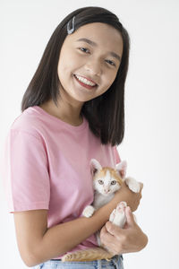 Portrait of a smiling young woman holding white background