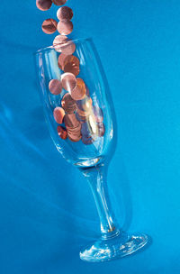 Close-up of glass of blue water on table
