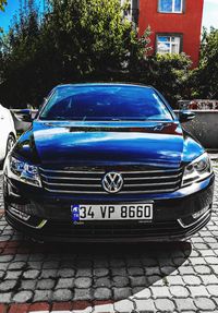 View of blue car on street in city