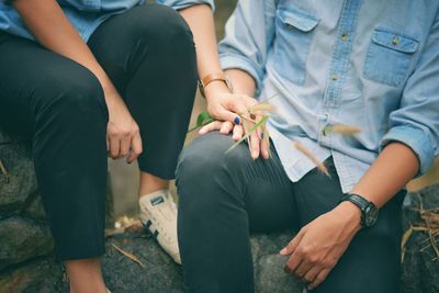 Midsection of couple holding hands