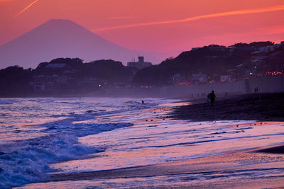 Scenic view of silhouette mountains against sky during sunset