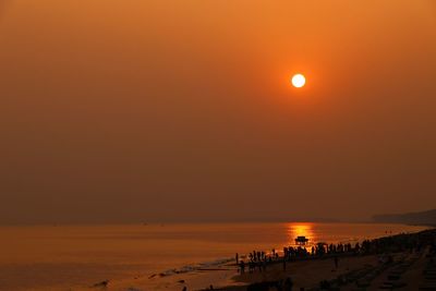 Scenic view of beach against sky during sunset