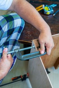 Woodworking. wood working project on work bench, with c-clamps and bar clamp.