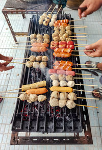 Person preparing food on barbecue grill