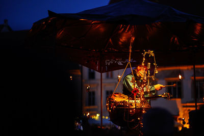 Illuminated lighting equipment hanging at night