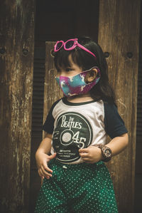 Full length of cute girl standing on wood