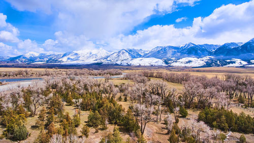 Scenic view of townscape and mountains against sky