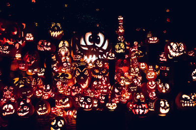 Low angle view of illuminated lanterns hanging at night