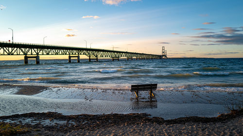 Pier over sea against sky during sunset