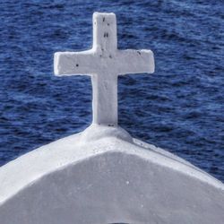 View of cross in front of sea