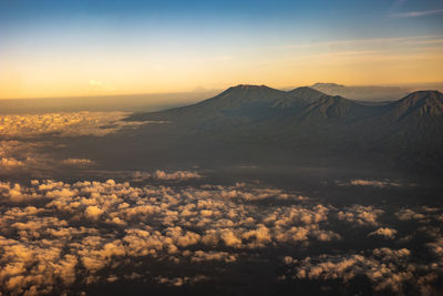 Scenic view of snowcapped mountains against sky during sunset