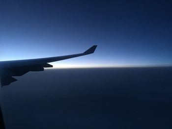 Airplane flying against clear blue sky