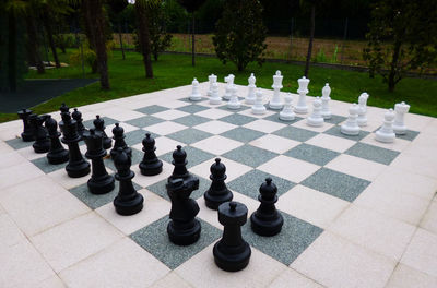 Close-up of chess pieces on table in park