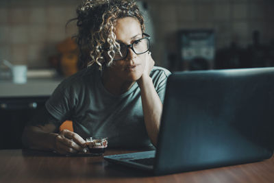 Young woman using laptop on table