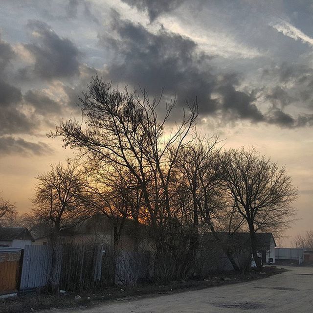 sunset, sky, bare tree, tree, cloud - sky, road, tranquility, scenics, tranquil scene, cloud, silhouette, nature, beauty in nature, cloudy, built structure, transportation, landscape, building exterior, outdoors, branch