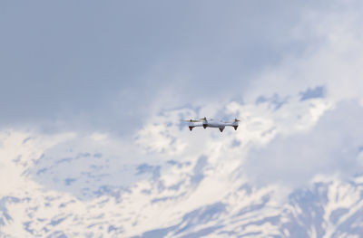 Low angle view of airplane flying in sky