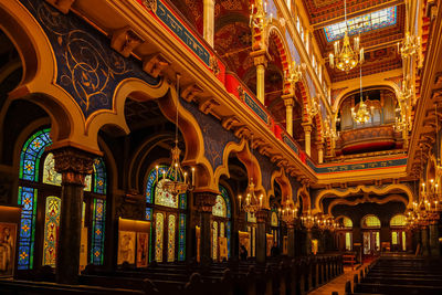 Low angle view of illuminated lighting equipment in synagogue building in prague 