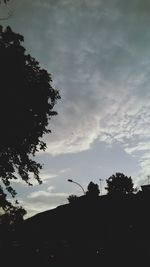 Silhouette trees against sky at sunset