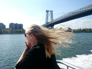 Tourists on bridge over river in city