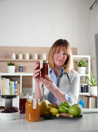 Young woman using mobile phone while sitting at home