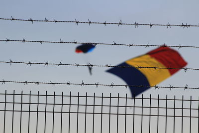 Low angle view of barbed wire against clear sky