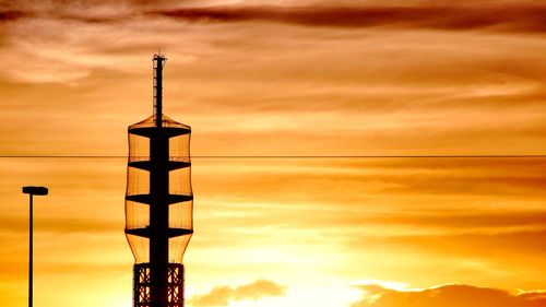 Low angle view of silhouette street light against sky during sunset