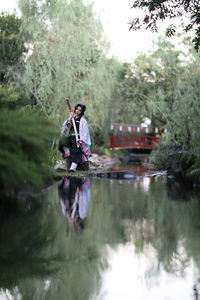 Rear view of man jumping in lake