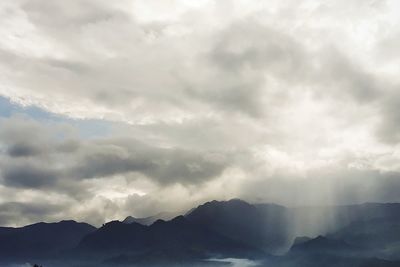 Scenic view of mountains against dramatic sky