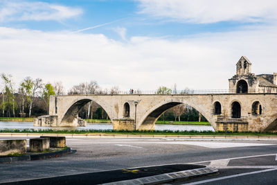 Arch bridge over river against sky