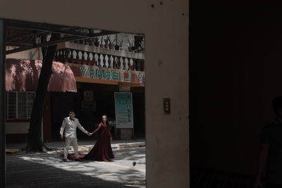 Couple walking in corridor of building