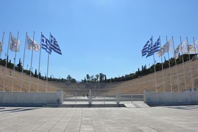 View of flags against clear blue sky