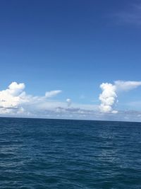 Scenic view of sea against blue sky